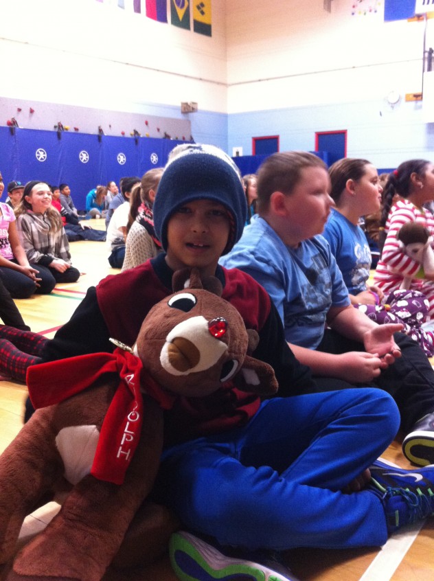 A student snuggling a Rudolph while we were caroling "Rudolph the Red-Nosed Reindeer" today. 